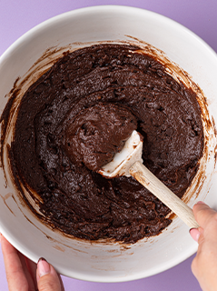Chocolate brownie batter in mixing bowl
